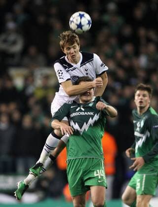 Tottenhams Roman Pavlyuchenko tussles with Bremens Philipp Bargfrede - Champions League, Tottenham Hotspur (white) vs. Werder Bremen (green), 24th November, 2010 EDITORIAL USE ONLY. No use with unauthorised audio, video, data, fixture lists, club league logos or live services. Online in-match use limited to 120 images, no video emulation. No use in betting, games or single club league player publications.