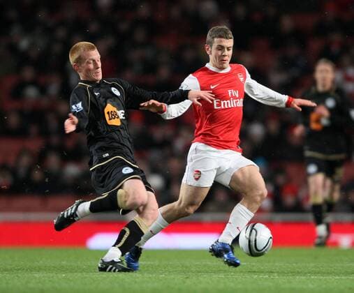 Arsenals Jack Wilshere r. tussles with Wigans Ben Watson Carling Cup quarter final Arsenal FC London vs Wigan Athletic 30th November, 2010 EDITORIAL USE ONLY. No use with unauthorised audio, video, data, fixture lists, club league logos or live services. Online in-match use limited to 120 images, no video emulation. No use in betting, games or single club league player publications.
