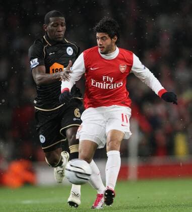 Arsenals Carlos Vela r. tussles with Wigans Hendry Thomas Carling Cup quarter final Arsenal FC London vs Wigan Athletic 30th November, 2010 EDITORIAL USE ONLY. No use with unauthorised audio, video, data, fixture lists, club league logos or live services. Online in-match use limited to 120 images, no video emulation. No use in betting, games or single club league player publications.
