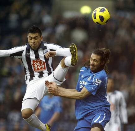 Gonzalo Jara of West Bromwich and Jonas Gutierrez of Newcastle - West Bromwich Albion (white) vs. Newcastle United (blue) EDITORIAL USE ONLY. No use with unauthorised audio, video, data, fixture lists, club league logos or live services. Online in-match use limited to 120 images, no video emulation. No use in betting, games or single club league player publications.