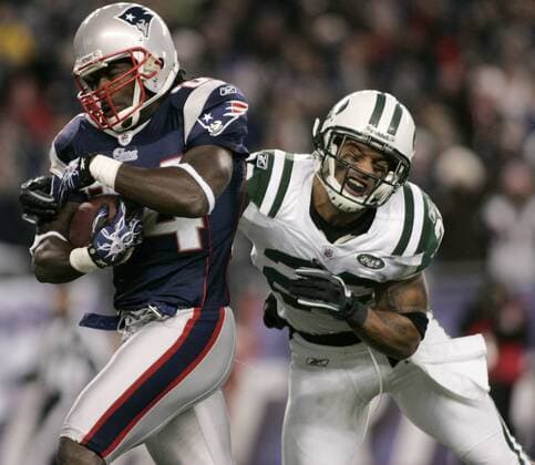 New England Patriots wide receiver Deion Branch shakes a tackle by New York Jets cornerback Dwight Lowery on a 25-yard touchdown reception in the first quarter at Gillette Stadium in Foxboro, Massachusetts on December 6, 2010.  BOS2010120603