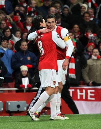 Arsenals Robin Van Persie celebrates scoring his sides opening goal with Samir Nasri (L) - Champions League: Arsenal FC (red) v Partizan Belgrade 8th December, 2010 - EDITORIAL USE ONLY. No use with unauthorised audio, video, data, fixture lists, club league logos or live services. Online in-match use limited to 120 images, no video emulation. No use in betting, games or single club league player publications.