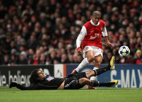 Arsenals Denilson tussles with Belgrades Sasa Ilic - Champions League: Arsenal FC (red) v Partizan Belgrade 8th December, 2010 - EDITORIAL USE ONLY. No use with unauthorised audio, video, data, fixture lists, club league logos or live services. Online in-match use limited to 120 images, no video emulation. No use in betting, games or single club league player publications.