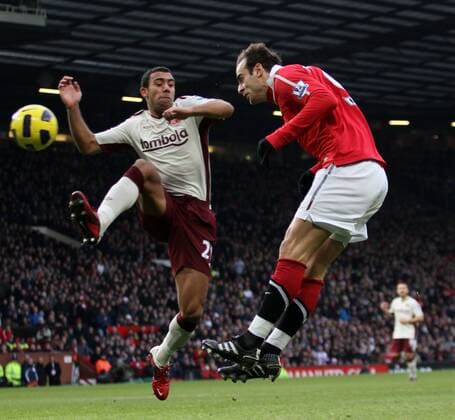 Manchester Uniteds Dimitar Berbatov (R) scoring his sides opening goal against Anton Ferdinand of AFC Sunderland. Barclays Premier League Manchester United v Sunderland 26th December, 2010 EDITORIAL USE ONLY. No use with unauthorised audio, video, data, fixture lists, club league logos or live services. Online in-match use limited to 120 images, no video emulation. No use in betting, games or single club league player publications. o0 Manu Tor