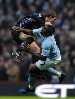Stephen Warnock of Aston Villa (L) challenges Micah Richards of Manchester City Barclays Premier League Manchester City v Aston Villa 28th December, 2010 EDITORIAL USE ONLY. No use with unauthorised audio, video, data, fixture lists, club league logos or live services. Online in-match use limited to 120 images, no video emulation. No use in betting, games or single club league player publications.