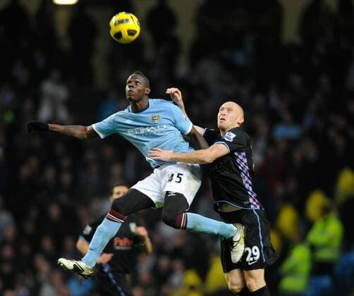 Mario Balotelli of Manchester City (F) challenges with James Collins of Aston Villa Barclays Premier League Manchester City v Aston Villa 28th December, 2010 EDITORIAL USE ONLY. No use with unauthorised audio, video, data, fixture lists, club league logos or live services. Online in-match use limited to 120 images, no video emulation. No use in betting, games or single club league player publications.