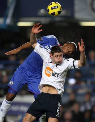 Chelseas Didier Drogba (back) tussles with Boltons Gary Cahill - Barclays Premier League FC Chelsea v Bolton Wanderers 29th December, 2010 EDITORIAL USE ONLY. No use with unauthorised audio, video, data, fixture lists, club league logos or live services. Online in-match use limited to 120 images, no video emulation. No use in betting, games or single club league player publications.