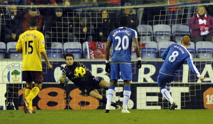 Ben Watson of Wigan Athletic scores from the penalty spot against goalkeeper Lukasz Fabianski - Barclays Premier League Wigan Athletic v Arsenal FC 29th December, 2010 EDITORIAL USE ONLY. No use with unauthorised audio, video, data, fixture lists, club league logos or live services. Online in-match use limited to 120 images, no video emulation. No use in betting, games or single club league player publications.