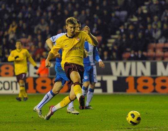 Nicklas Bendtner of Arsenal scores the second goal - Barclays Premier League, Wigan Athletic (blue) vs Arsenal FC (yellow) 29th December, 2010 EDITORIAL USE ONLY. No use with unauthorised audio, video, data, fixture lists, club league logos or live services. Online in-match use limited to 120 images, no video emulation. No use in betting, games or single club league player publications.