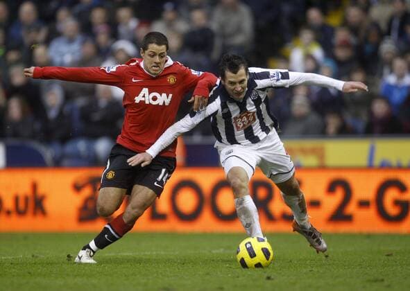 Manchester United goalscorer Javier Chicharito Hernandez makes life difficult for West Brom defender Marek Cech - Barclays Premier League, West Bromwich Albion (white) vs. Manchester United (red) 1st January, 2011 EDITORIAL USE ONLY. No use with unauthorised audio, video, data, fixture lists, club league logos or live services. Online in-match use limited to 120 images, no video emulation. No use in betting, games or single club league player publications.