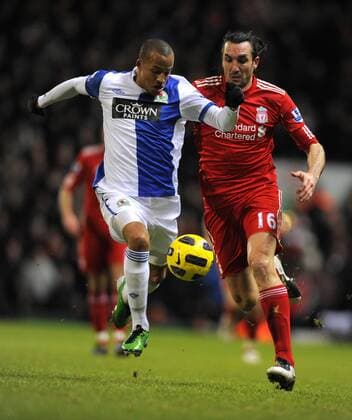 Martin Olsson of Blackburn Rovers and Sotirios Kyrgiakos of Liverpool, Blackburn Rovers (white) - FC Liverpool (red) EDITORIAL USE ONLY. No use with unauthorised audio, video, data, fixture lists, club league logos or live services. Online in-match use limited to 120 images, no video emulation. No use in betting, games or single club league player publications.