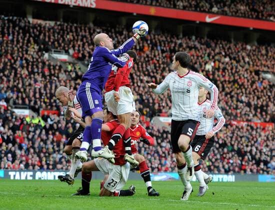 Jose Manuel Reina (2.L) of Liverpool punches clear - FA Cup 3rd Round - Manchester United (ManU) vs. Liverpool FC 1:0 - EDITORIAL USE ONLY. No use with unauthorised audio, video, data, fixture lists, club league logos or live services. Online in-match use limited to 120 images, no video emulation. No use in betting, games or single club league player publications.