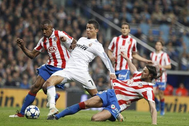 13.01.2011 Spanish Copa del Rey from the Santiago Bernebeu. Real Madrid vs Atletico Madrid 3-1. Luis Perea (L) and Tomas Ujfalusi (R, Atletico) defending against Cristiano Ronaldo (Real). xEnriquexdexlaxFuentex  ActionPlus11129883 Content restricted for UK based newspaper