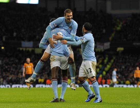 Yaya Toure of Manchester City (L) celebrates his goal with new signing Edin Dzeko of Manchester City - Manchester City - Wolverhampton Wanderers - EDITORIAL USE ONLY. No use with unauthorised audio, video, data, fixture lists, club league logos or live services. Online in-match use limited to 120 images, no video emulation. No use in betting, games or single club league player publications.