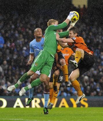 Joe Hart of Manchester City (L) saves under pressure from Kevin Doyle of Wolverhampton Wanderers - Manchester City - Wolverhampton Wanderers - EDITORIAL USE ONLY. No use with unauthorised audio, video, data, fixture lists, club league logos or live services. Online in-match use limited to 120 images, no video emulation. No use in betting, games or single club league player publications.