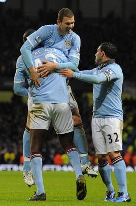 Yaya Toure of Manchester City (L) celebrates his goal with new signing Edin Dzeko of Manchester City - Manchester City - Wolverhampton Wanderers - EDITORIAL USE ONLY. No use with unauthorised audio, video, data, fixture lists, club league logos or live services. Online in-match use limited to 120 images, no video emulation. No use in betting, games or single club league player publications.