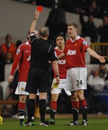 Football - Premier league - Tottenham Hotspur (white) v Manchester United (red) 16 01 2011 Referee Mike Dean produces the red card to send off Rafael da Silva (ManU, C) 