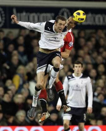 Tottenhams Peter Crouch tussles with Manchester Uniteds Rio Ferdinand - Barclays Premier League, Tottenham Hotspur (white) v Manchester United Manu (red) 16th January, 2011 EDITORIAL USE ONLY. No use with unauthorised audio, video, data, fixture lists, club league logos or live services. Online in-match use limited to 120 images, no video emulation. No use in betting, games or single club league player publications.