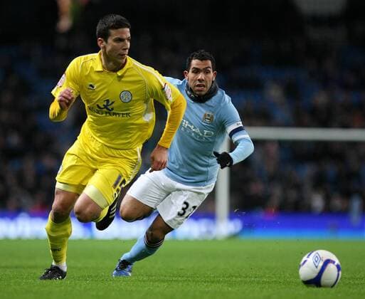 Football - FA Cup Third Round Replay - Manchester City vs. Leicester City Carlos Tevez of Manchester City (R) closes down Leicester s Bruno Berner at the City of Manchester Stadium 