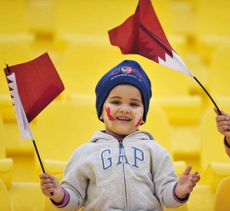 A Qatari boy cheers for the team before the 2011 Asian Cup quarterfinal football match in Doha, capital of Qatar - 