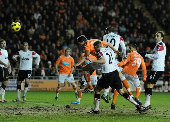 Craig Cathcart of Blackpool (orange C) scores the first goal --- Blackpool FC vs. Manchester United EDITORIAL USE ONLY. No use with unauthorised audio, video, data, fixture lists, club league logos or live services. Online in-match use limited to 120 images, no video emulation. No use in betting, games or single club league player publications. o0 Tor