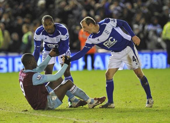 Cameron Jerome (2L) and Lee Bowyer (R) of Birmingham console Carlton Cole at the end of the game - Carling Cup Semi Final 2nd Leg - Birmingham City v West Ham United - 26th January, 2011 EDITORIAL USE ONLY. No use with unauthorised audio, video, data, fixture lists, club league logos or live services. Online in-match use limited to 120 images, no video emulation. No use in betting, games or single club league player publications.