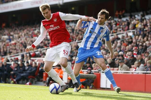 FA Cup Fourth Round - Arsenal FC London - Huddersfield Town - Arsenal s Nicklas Bendtner (L) and Huddersfield s Kevin Kilbane in action at The Emirates Stadium 
