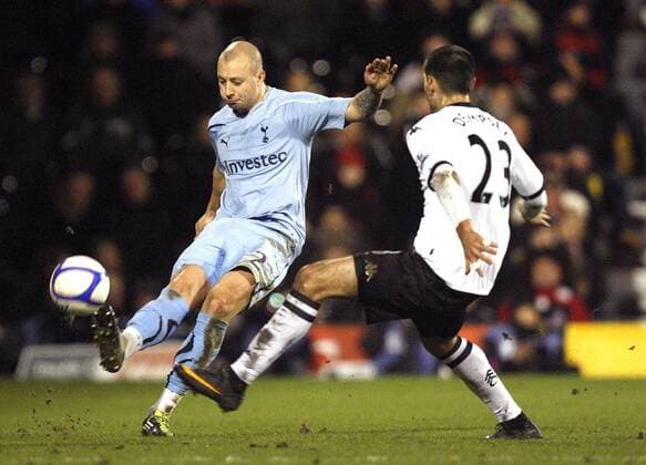 Alan Hutton of Tottenham Hotspur plays the ball past Clint Dempsey of Fulham EON FA Cup 4th Round Fulham FC (White) v Tottenham Hotspur (blue) 30th January, 2011 EDITORIAL USE ONLY. No use with unauthorised audio, video, data, fixture lists, club league logos or live services. Online in-match use limited to 120 images, no video emulation. No use in betting, games or single club league player publications.