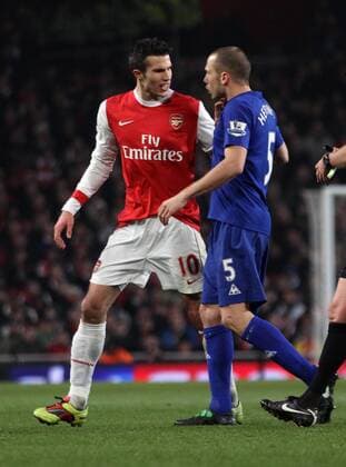 Arsenal FC (red)s Robin Van Persie tussles with Everton FCs John Heitinga Barclays Premier League Arsenal FC (red) v Everton FC 1st February, 2011 EDITORIAL USE ONLY. No use with unauthorised audio, video, data, fixture lists, club league logos or live services. Online in-match use limited to 120 images, no video emulation. No use in betting, games or single club league player publications.