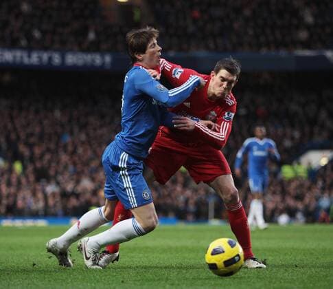 Fernando Torres (L) of Chelsea gets tackled by Daniel Agger of Liverpool Barclays Premier League, Chelsea FC London vs Liverpool FC. 6th February, 2011 EDITORIAL USE ONLY. No use with unauthorised audio, video, data, fixture lists, club league logos or live services. Online in-match use limited to 120 images, no video emulation. No use in betting, games or single club league player publications.