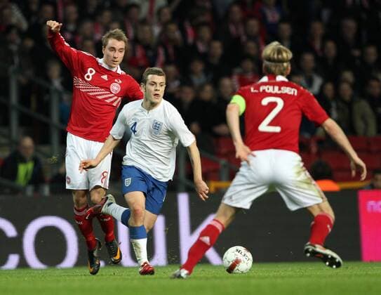 Denmarks Christian Eriksen (L) tussles with Englands Jack Wilshere International Friendly Denmark v England 9th February, 2011 EDITORIAL USE ONLY. No use with unauthorised audio, video, data, fixture lists, club league logos or live services. Online in-match use limited to 120 images, no video emulation. No use in betting, games or single club league player publications.