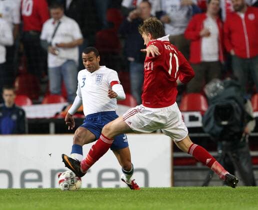 Denmarks Nicklas Bendtner (R) tussles with Englands Ashley Cole International Friendly Denmark v England 9th February, 2011 EDITORIAL USE ONLY. No use with unauthorised audio, video, data, fixture lists, club league logos or live services. Online in-match use limited to 120 images, no video emulation. No use in betting, games or single club league player publications.