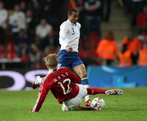 Denmarks Daniel Wass (L) tussles with Englands Ashley Cole International Friendly Denmark v England 9th February, 2011 EDITORIAL USE ONLY. No use with unauthorised audio, video, data, fixture lists, club league logos or live services. Online in-match use limited to 120 images, no video emulation. No use in betting, games or single club league player publications.