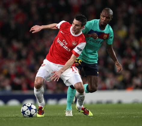 Arsenals Robin Van Persie tussles with Barcelonas Eric Abidal --- UEFA Champions League 1st Leg last 16 Arsenal London (red) v FC Barcelona Barca (green) 16th February, 2011 EDITORIAL USE ONLY. No use with unauthorised audio, video, data, fixture lists, club league logos or live services. Online in-match use limited to 120 images, no video emulation. No use in betting, games or single club league player publications.