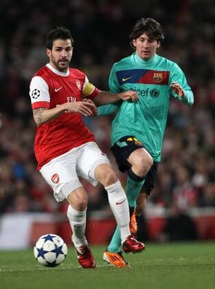 Arsenals Cesc Fabregas tussles with Barcelonas Lionel Messi --- UEFA Champions League 1st Leg last 16 Arsenal London (red) v FC Barcelona Barca (green) 16th February, 2011 EDITORIAL USE ONLY. No use with unauthorised audio, video, data, fixture lists, club league logos or live services. Online in-match use limited to 120 images, no video emulation. No use in betting, games or single club league player publications.