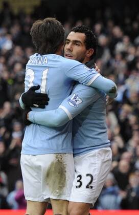 Carlos Tevez of Manchester City (R) celebrates scoring third goal - FA Cup 4th Round replay Manchester City - Notts County - EDITORIAL USE ONLY. No use with unauthorised audio, video, data, fixture lists, club league logos or live services. Online in-match use limited to 120 images, no video emulation. No use in betting, games or single club league player publications.