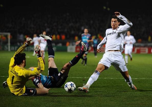 Olympique Lyon (blue) - Real CF Madrid (white), Cristiano Ronaldo of Real Madrid attempts to put the ball past Hugo Lloris of Lyon - 