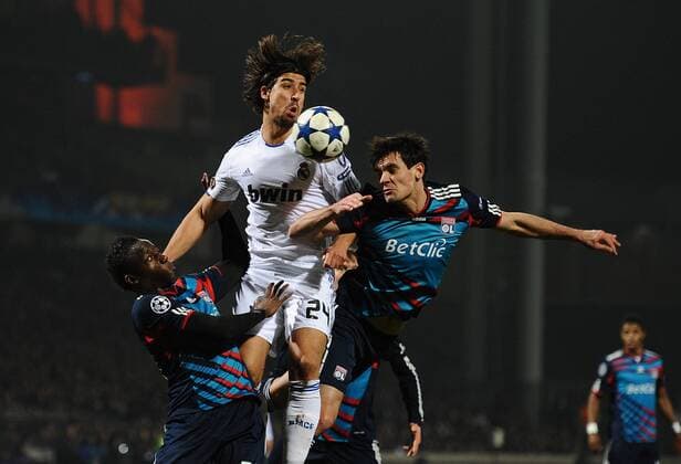 Olympique Lyon (blue) - Real CF Madrid (white), Sami Khedira of Real Madrid rises above Lyons Jeremy Toulalan (R) and Aly Cissokho - 