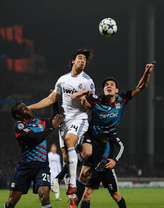 Olympique Lyon (blue) - Real CF Madrid (white), Sami Khedira of Real Madrid rises above Lyons Jeremy Toulalan (R) and Aly Cissokho - 