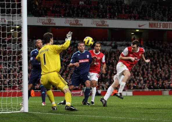 Arsenals Sebastien Squillaci (R) scoring his sides opening goal - Premier League - Arsenal FC London - Stoke City - EDITORIAL USE ONLY. No use with unauthorised audio, video, data, fixture lists, club league logos or live services. Online in-match use limited to 120 images, no video emulation. No use in betting, games or single club league player publications.