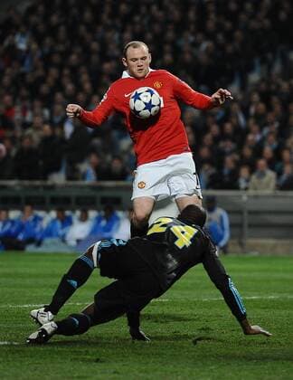 Football - Champions League Round of 16 First Leg - Olympique Marseille (blue) vs. Manchester United ManU (red) --- Wayne Rooney of Manchester United chests down the ball at the Stade Velodrome, Marseille 