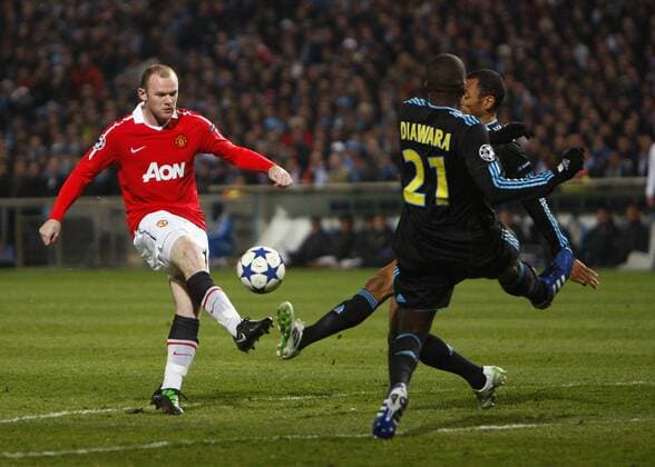 Wayne Rooney of Manchester United has a shot blocked --- Champions League Round of 16 First Leg - Olympique Marseille (blue) vs. Manchester United ManU (red) --- EDITORIAL USE ONLY. No use with unauthorised audio, video, data, fixture lists, club league logos or live services. Online in-match use limited to 120 images, no video emulation. No use in betting, games or single club league player publications.