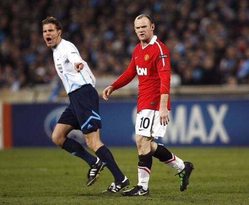 A frustrated Wayne Rooney of Manchester United and Referee Dr Felix Brych (GER) --- Champions League Round of 16 First Leg - Olympique Marseille (blue) vs. Manchester United ManU (red) --- EDITORIAL USE ONLY. No use with unauthorised audio, video, data, fixture lists, club league logos or live services. Online in-match use limited to 120 images, no video emulation. No use in betting, games or single club league player publications.
