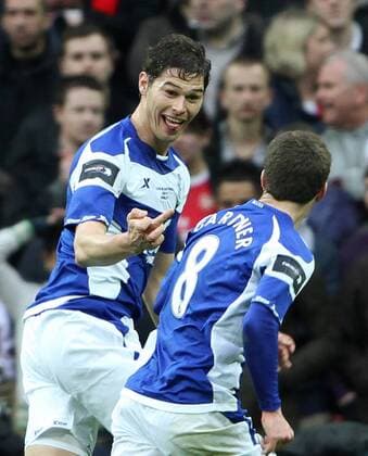 Birminghams Nikola Zigic (L) celebrates scoring his sides opening goal by giving his middle finger to teamate Craig Gardner --- Carling Cup Final, Arsenal London (red) v Birmingham City (blue), 27th February, 2011 EDITORIAL USE ONLY. No use with unauthorised audio, video, data, fixture lists, club league logos or live services. Online in-match use limited to 120 images, no video emulation. No use in betting, games or single club league player publications. o0 Finale