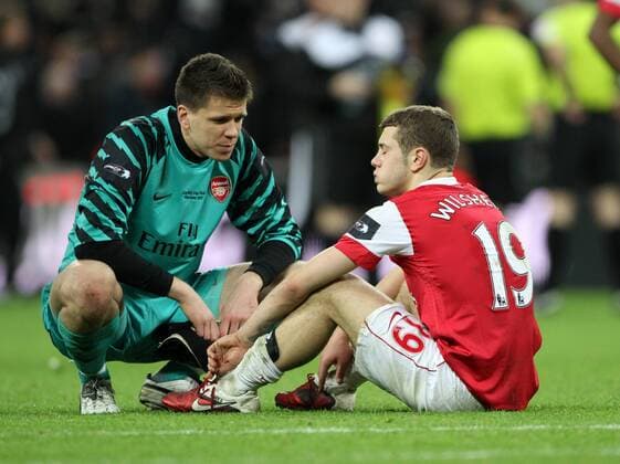 Arsenals Jack Wilshere looks on dejected at the final whistle with keeper Wojciech Szczesny --- Carling Cup Final, Arsenal London (red) v Birmingham City (blue), 27th February, 2011 EDITORIAL USE ONLY. No use with unauthorised audio, video, data, fixture lists, club league logos or live services. Online in-match use limited to 120 images, no video emulation. No use in betting, games or single club league player publications.
