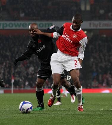 Arsenal FC s Abou Diaby tussles with Leyton Orients Terrell Forbes - EON FA Cup 5th Round Replay Arsenal FC (red) v Leyton Orient (black) 2nd March, 2011 EDITORIAL USE ONLY. No use with unauthorised audio, video, data, fixture lists, club league logos or live services. Online in-match use limited to 120 images, no video emulation. No use in betting, games or single club league player publications.