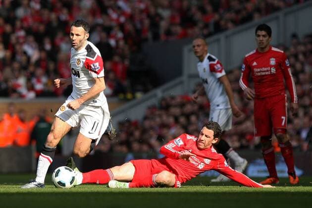 Football - Premier League - Liverpool FC vs. Manchester United (ManU) --- Ryan Giggs of Manchester United (ManU white) passes a challenge from Maxi Rodriguez of Liverpool FC (red) at Anfield 