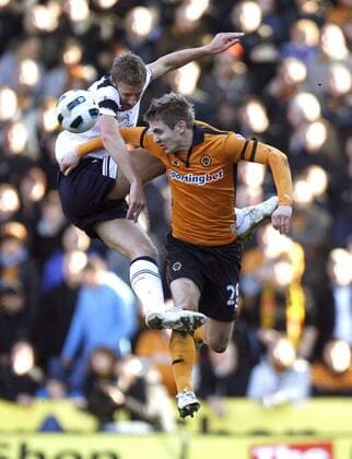 Michael Dawson(L) of Tottenham Hotspur and Kevin Doyle of Wolverhampton Wanderers leap for the ball Barclays Premier League Wolverhampton Wanderers v Tottenham Hotspur 6th March, 2011 EDITORIAL USE ONLY. No use with unauthorised audio, video, data, fixture lists, club league logos or live services. Online in-match use limited to 120 images, no video emulation. No use in betting, games or single club league player publications.