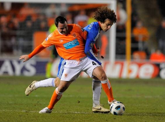Andy Reid (L) of Blackpool FC takes on David Luiz of Chelsea FC London Barclays Premier League Blackpool v Chelsea 7th March, 2011 EDITORIAL USE ONLY. No use with unauthorised audio, video, data, fixture lists, club league logos or live services. Online in-match use limited to 120 images, no video emulation. No use in betting, games or single club league player publications.