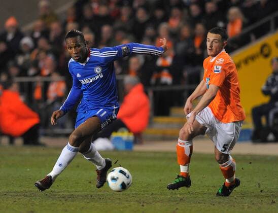 Didier Drogba (L) of Chelsea FC London turns Neal Eardley of Blackpool FC Barclays Premier League Blackpool v Chelsea 7th March, 2011 EDITORIAL USE ONLY. No use with unauthorised audio, video, data, fixture lists, club league logos or live services. Online in-match use limited to 120 images, no video emulation. No use in betting, games or single club league player publications.